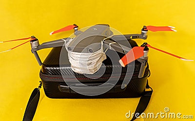 Drones forbidden concept: Unfolded drone covered by medical face mask. No fly zone Stock Photo