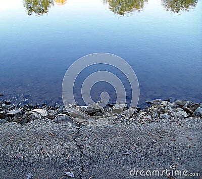 Drop off leading to a lake`s reflection Stock Photo