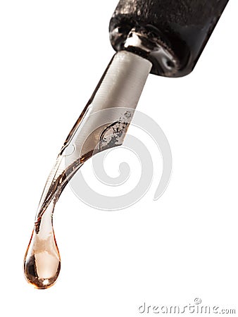 Drop of transparent fluid on nib of pen Stock Photo
