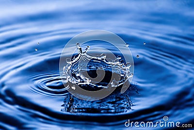 Drop of water on blue Stock Photo