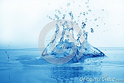 Drop of water in puddle in blue Stock Photo