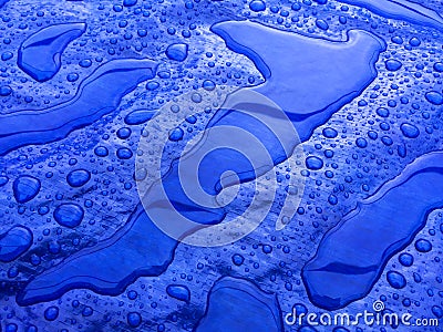 Droplets of rainwater on the blue tarp Stock Photo