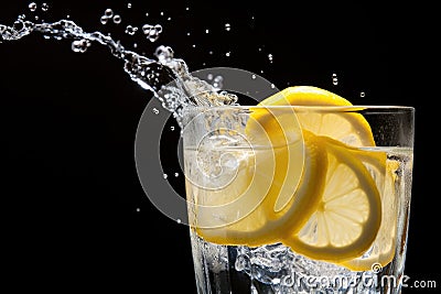 droplets of water falling on a glass of freshly made lemonade Stock Photo