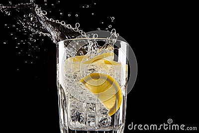 droplets of water falling on a glass of freshly made lemonade Stock Photo