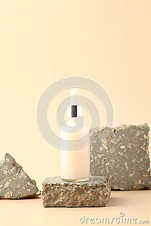 Dropper bottle with white serum liquid on stone pedestal Stock Photo