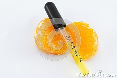 A Dropper of Vitamin C Serum on Orange Wedges Stock Photo