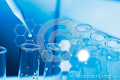 Dropping chemical liquid to test tube, laboratory research and development concept Stock Photo