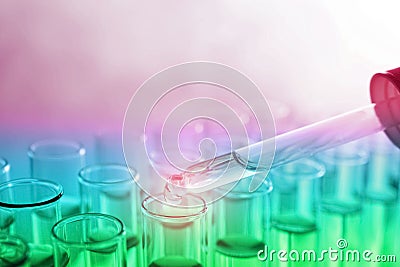 Dropping sample into test tube with liquid on background, closeup. Laboratory analysis Stock Photo