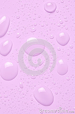 Drops of micellar water or cosmetic tonic on a pink background. Close-up, macro photography Stock Photo