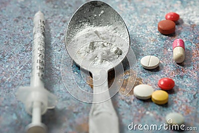 Drug addiction concept with heroine packet and syringe on black backgrund Stock Photo