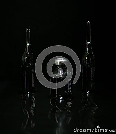 The drug is in ampoules. Injection medications on a black background in reflection Stock Photo