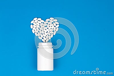 Drug heart shape and bottle of pills Stock Photo