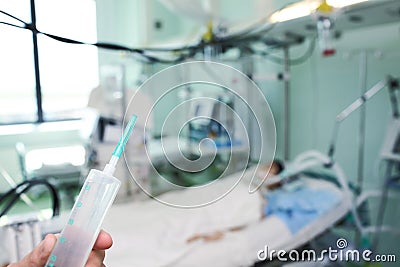 Drug syringe in the nurses hand as a concept of patient`s treatm Stock Photo