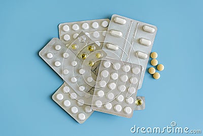 drug therapy, pharmaceutical branch, a group of different colorful pills in blister packs on blue background Stock Photo