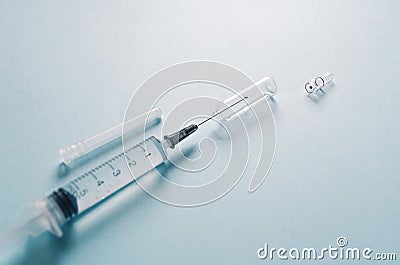 Drug treatment concept. an opened medical ampoule and a sterile syringe for injection. medicines, vaccine, vitamins, painkiller Stock Photo