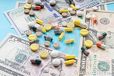 Drugs and money. Colorful pills and capsules on dollar banknotes. concept of high cost treatment, preservation of health and Stock Photo
