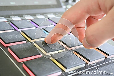 Drum machine pads being hit by hand / fingers Stock Photo