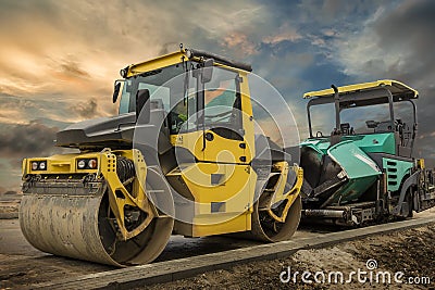 Drum roller and asphalt spreading machine. Stock Photo
