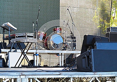 Drum set, microphones and speakers on stage Stock Photo