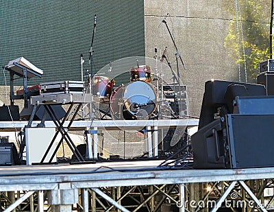 Drum set, microphones and speakers on stage Stock Photo