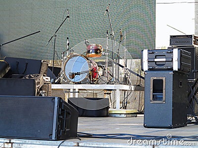 Drum set, microphones and speakers on stage Stock Photo