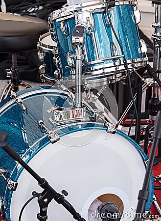 drum set and microphones standing outdoors stage before performance of street musicians Stock Photo