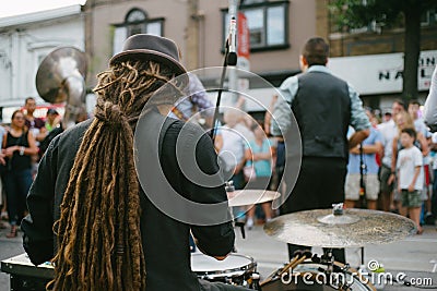 Drummer and band performing live music on a street Editorial Stock Photo