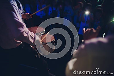 Drummer.The guy holding the drumsticks in his hand.Young man with drumsticks.A bearded man holding a stick in his hands Stock Photo