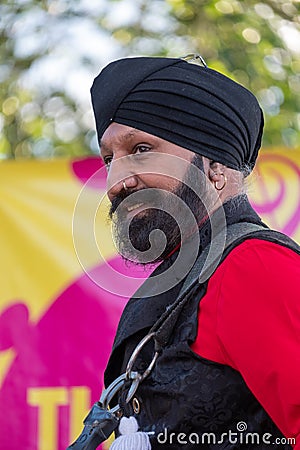 Drummer Jonny Kalsi from the Dhol Foundation playing at an annual concert of Jewish Klezmer music in Regent`s Park in London UK. Editorial Stock Photo