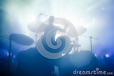 Drummer playing on drums on music concert. Club lights Stock Photo