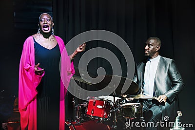 Drummer and singer performing in an event Stock Photo