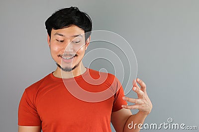 Drunk Asian man is holding a bottle. Stock Photo