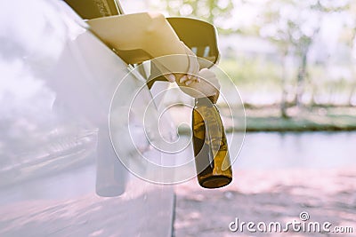 Drunk asian woman drinking alcohol while driving car on road,Women drive her car with a bottle of beer,Dangerous driving concept Stock Photo