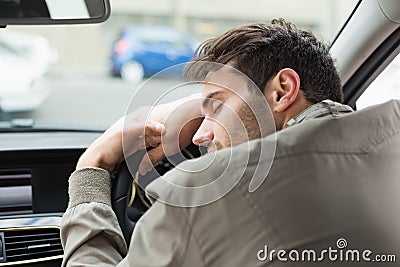 Drunk man slumped on steering wheel Stock Photo