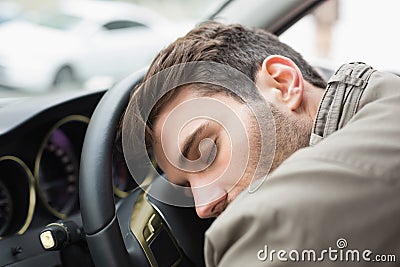 Drunk man slumped on steering wheel Stock Photo