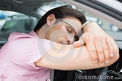 Drunk man slumped on steering wheel Stock Photo