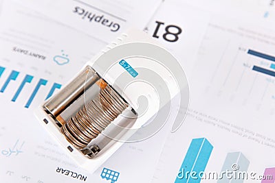 Dry battery chargers for dollar coins on financial charts Stock Photo