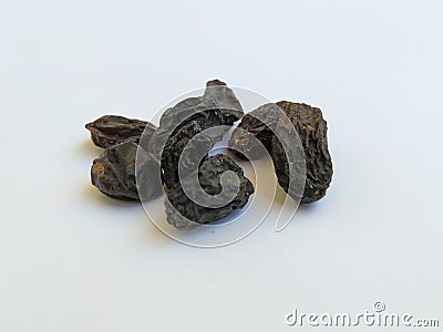 Closeup of dry black raisin fruit in a white background. Heap of blue raisin isolated on white Stock Photo