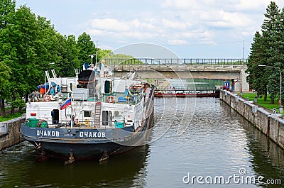 Dry cargo ship in ship lock of Uglich hydroelectric power Editorial Stock Photo