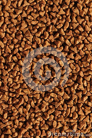 Dry cat food texture background. Medium size triangular pieces. Food pattern. Stock Photo