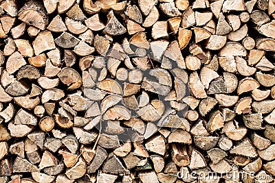 Dry chopped firewood stacked up in a pile Stock Photo