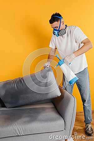 Dry cleaner& x27;s employee removing dirt from furniture in flat, closeup. Cleaning company using professional equipment. Stock Photo