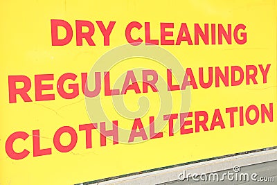 dry cleaning regular laundry cloth alteration writing caption text sign in red. ph Stock Photo