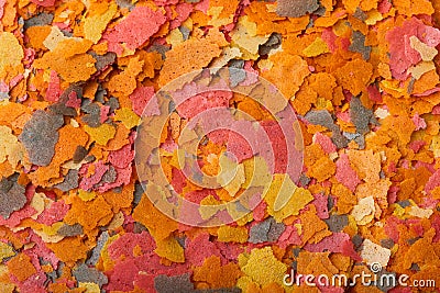 Dry compound fish feed flakes background Stock Photo