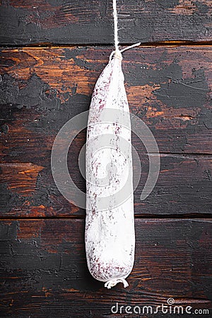 Dry cured longaniza sausage on old wooden table, topview Stock Photo