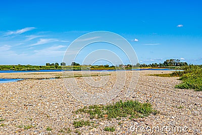 Dry floodplain on bank of Maas river with little water Stock Photo