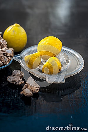 Dry ginger with lemon and its juice. Stock Photo