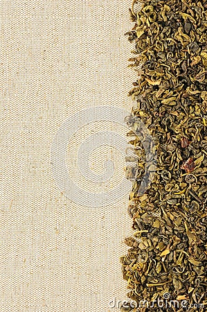 Dry green tea leaves on a sackcloth Stock Photo