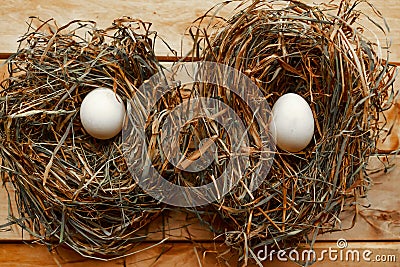 Dry hay nest with chicken eggs, top view. Easter concept. Stock Photo