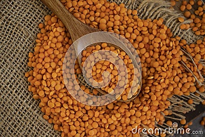 Dry lentils spoon on wooden background agriculture Stock Photo